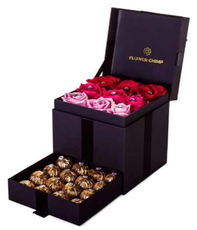 a stylish black box with nine roses in varying shades of red, and a set of chocolates in a pull-out compartment underneath.