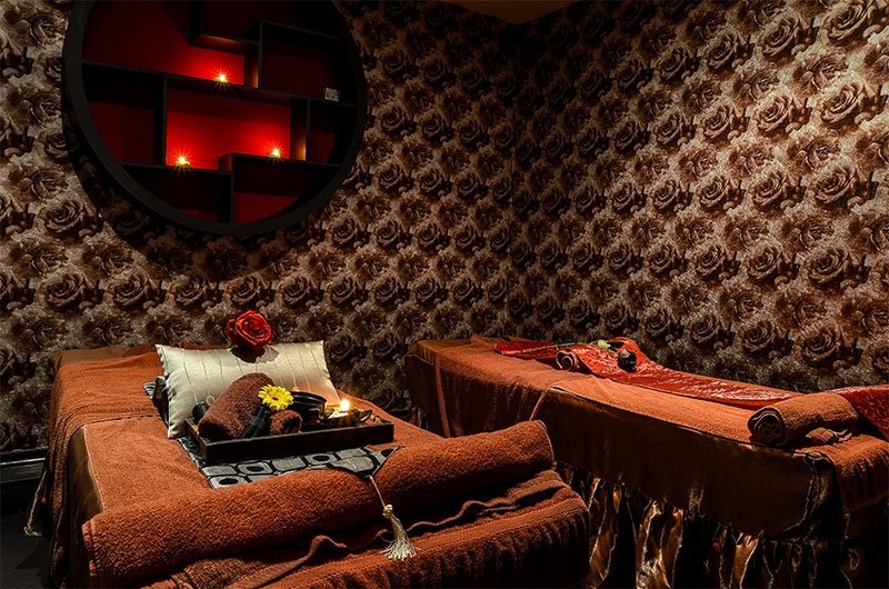Cosy interior of a Thai massage room in Le Spa with two massage beds