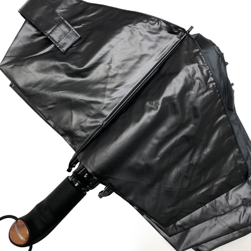 The Hailstorm umbrella in an unstrapped position, laid out on a flat surface
