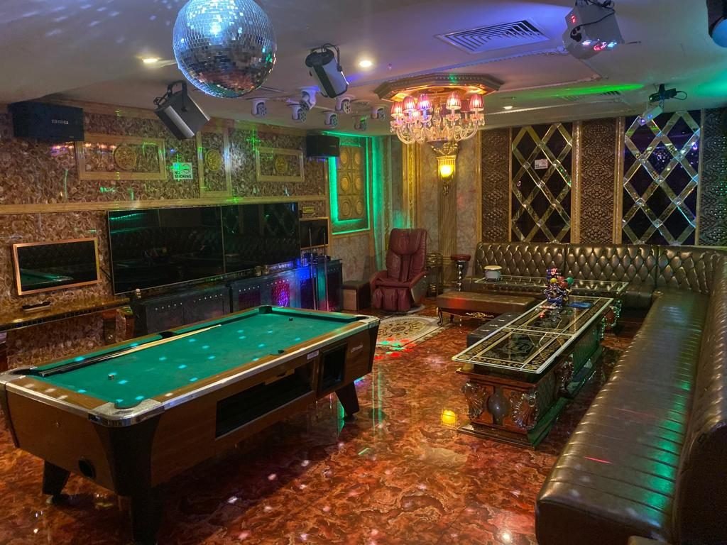 Party world ktv room with disco ball lights and a billiard table