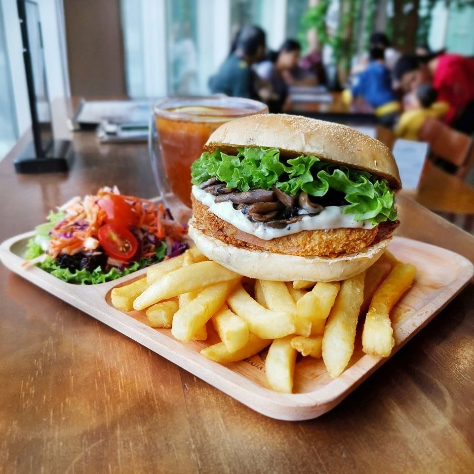 vegan burger with fries, salad, and tea