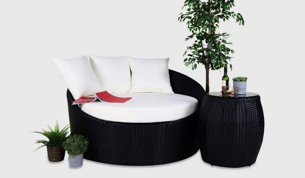 Round sofa with cushions and coffee table
