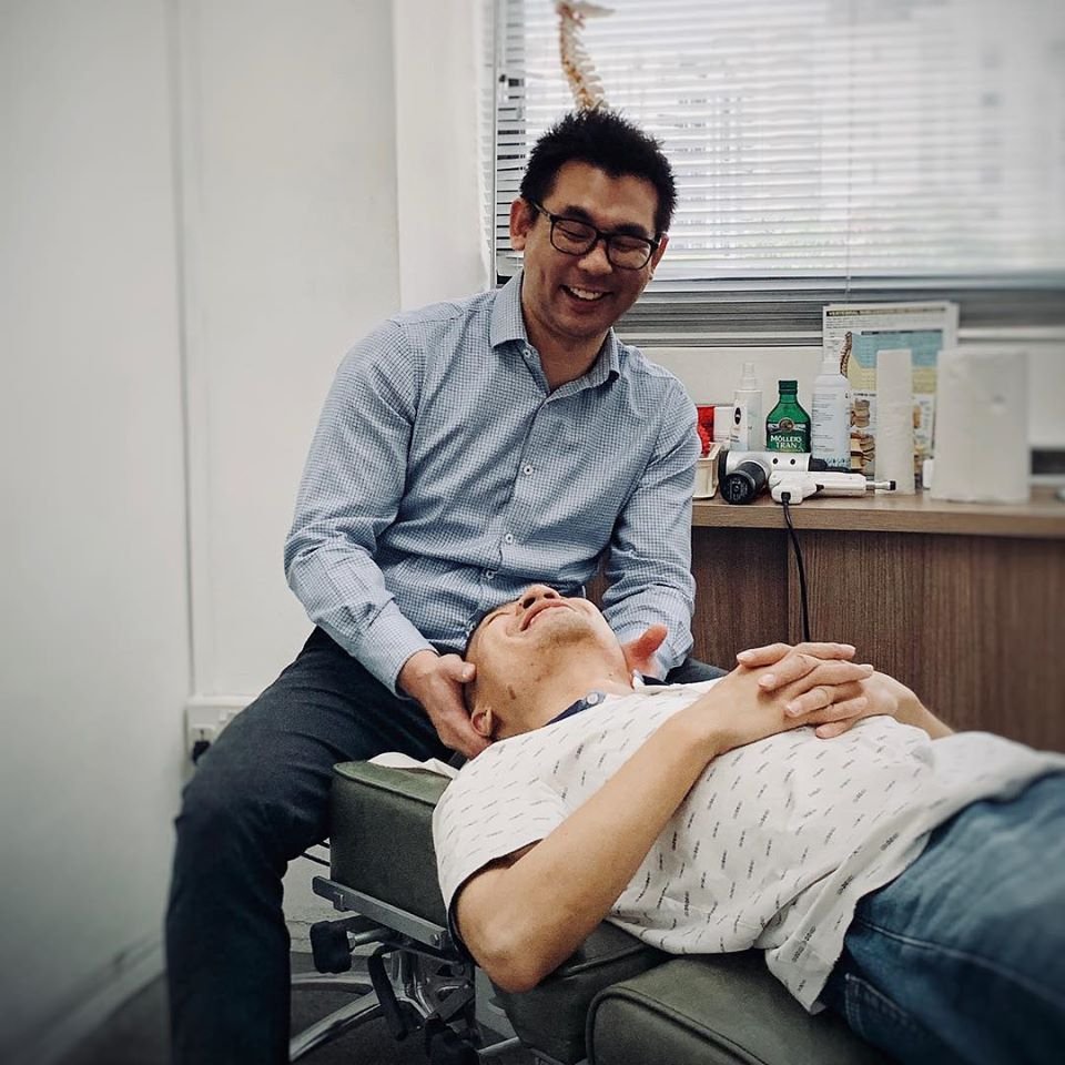 chiropractor checking up on his clients neck