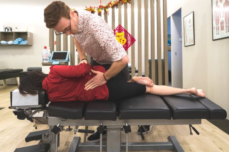 chiropractor performing spinal alignment in a clinic in singapore
