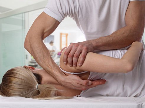 chiropractor performing a session with a client